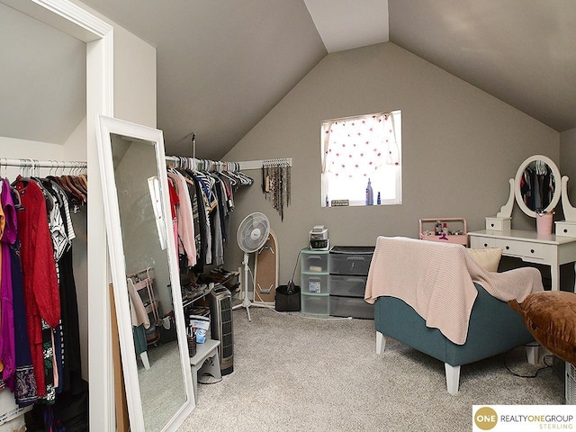 walk in closet featuring lofted ceiling and carpet