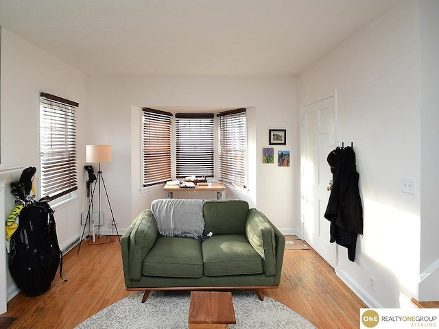 living room featuring light wood-type flooring and baseboards