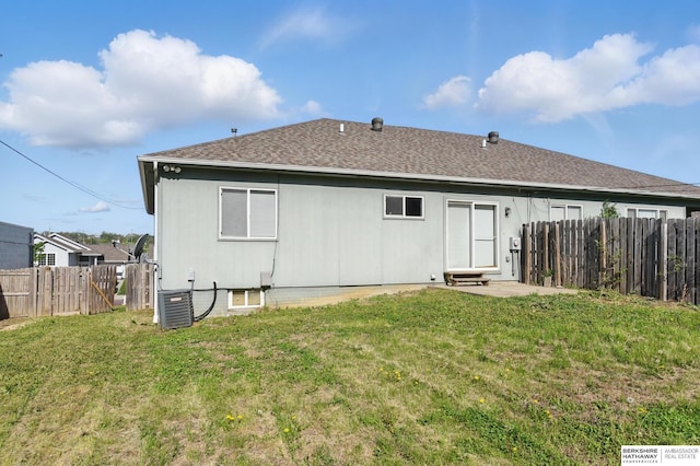 rear view of property featuring central AC unit, roof with shingles, a patio, and a gate