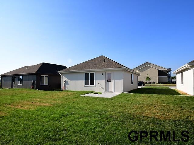 back of property with a patio and a yard