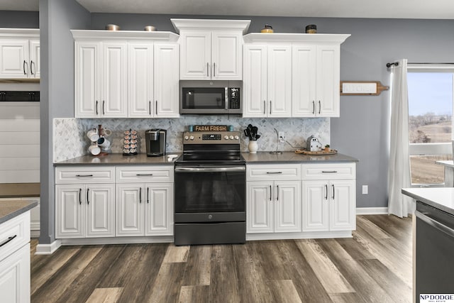 kitchen with white cabinetry, dark wood-type flooring, decorative backsplash, and stainless steel appliances