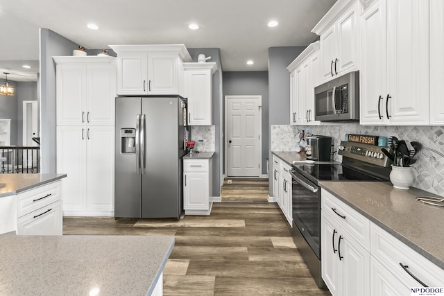 kitchen with recessed lighting, appliances with stainless steel finishes, white cabinetry, and dark wood-style flooring