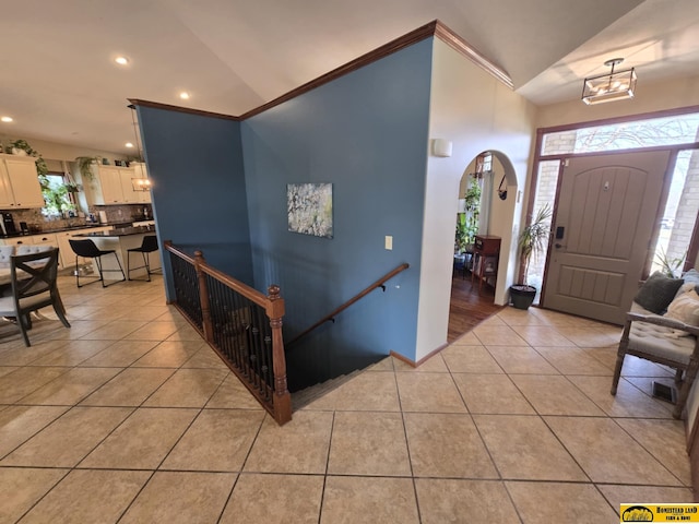 foyer entrance featuring light tile patterned floors, recessed lighting, and vaulted ceiling