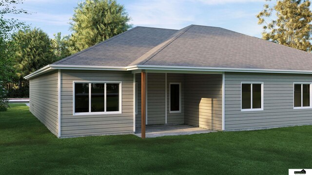 back of house featuring a lawn, a shingled roof, a patio, and an attached carport
