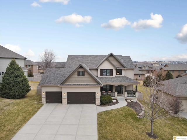view of front of property featuring a garage, a front lawn, a shingled roof, concrete driveway, and a porch
