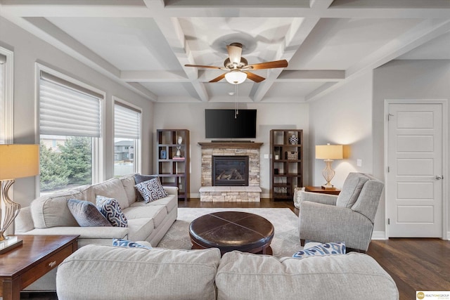 living room featuring a ceiling fan, a fireplace, wood finished floors, beamed ceiling, and coffered ceiling