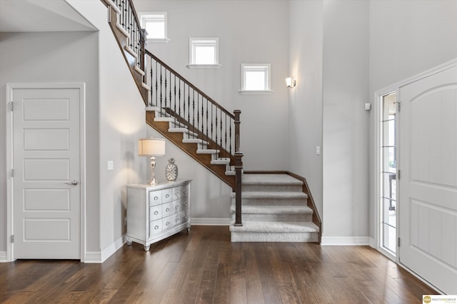entryway featuring stairway, wood-type flooring, and baseboards