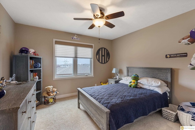 bedroom with baseboards, light carpet, and a ceiling fan