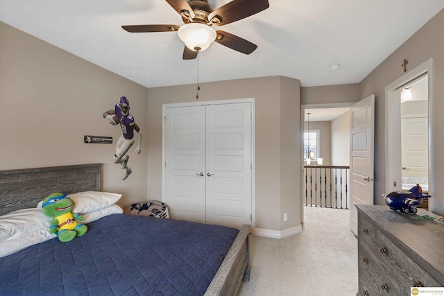 bedroom with a closet, a ceiling fan, and baseboards