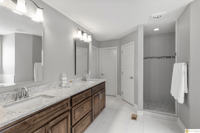bathroom featuring a sink, baseboards, a stall shower, and double vanity