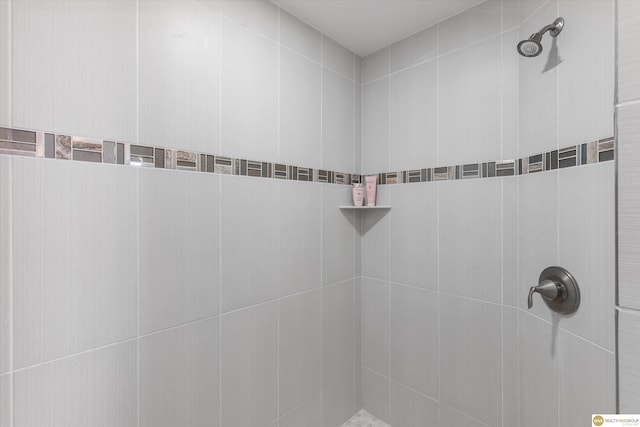 full bath featuring a tile shower