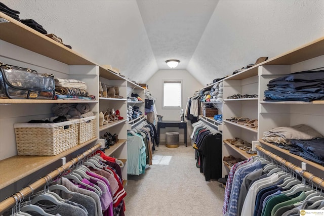 spacious closet featuring light carpet and lofted ceiling