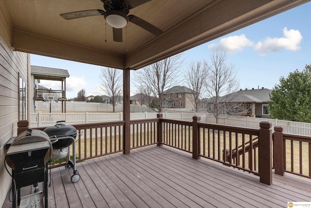 deck featuring a fenced backyard, ceiling fan, and a residential view