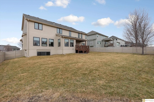 rear view of property with a lawn, a fenced backyard, and a deck