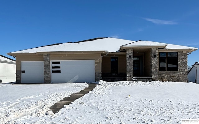 prairie-style home featuring stone siding and an attached garage