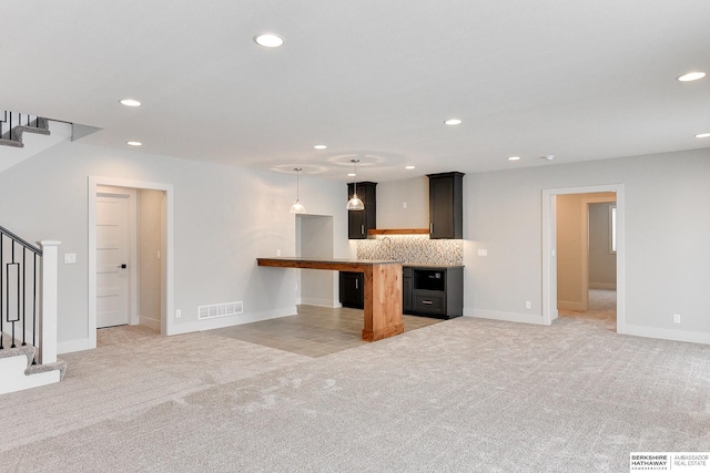 unfurnished living room featuring recessed lighting, stairway, light colored carpet, and visible vents