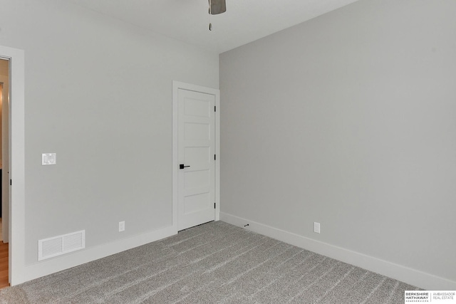 empty room with visible vents, baseboards, a ceiling fan, and carpet flooring