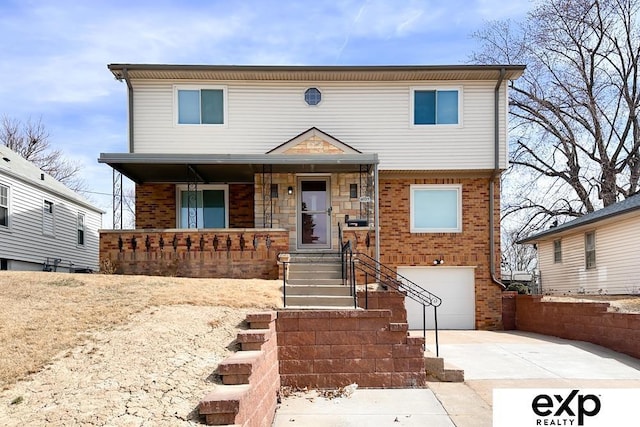 6027 S 36th St, Omaha, NE 68107 - view of front of property with concrete driveway, a porch, brick siding, and a garage