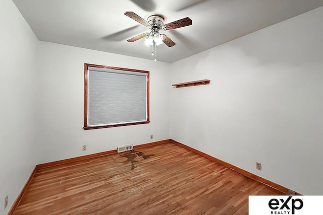 6027 S 36th St, Omaha, NE 68107 - unfurnished room with visible vents, baseboards, a ceiling fan, and wood finished floors