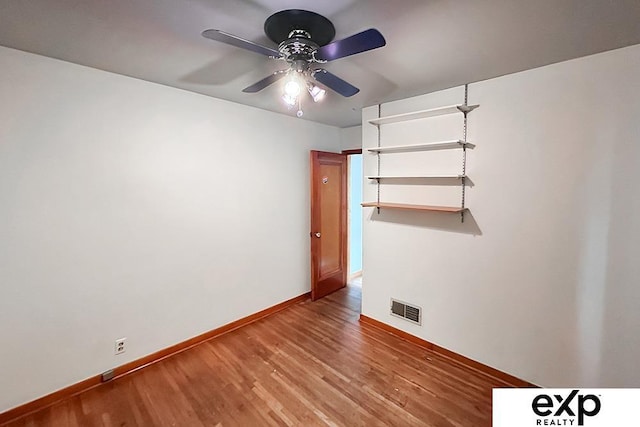 6027 S 36th St, Omaha, NE 68107 - empty room with visible vents, baseboards, a ceiling fan, and wood finished floors
