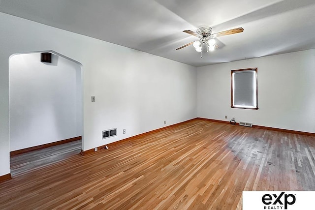 6027 S 36th St, Omaha, NE 68107 - unfurnished room featuring visible vents, baseboards, a ceiling fan, and wood finished floors