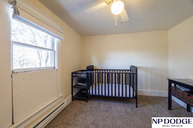 1042 Seward St, Seward, NE 68434 - carpeted bedroom with a ceiling fan, a baseboard heating unit, and baseboards