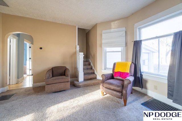 1042 Seward St, Seward, NE 68434 - living area with visible vents, carpet flooring, and stairs