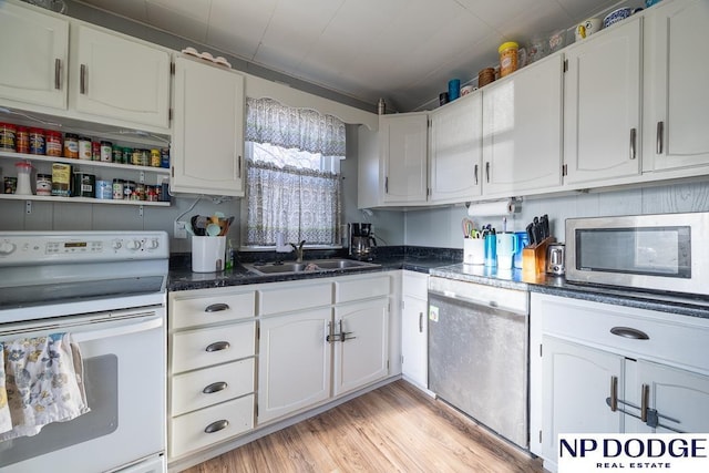 1042 Seward St, Seward, NE 68434 - kitchen featuring light wood finished floors, white cabinetry, stainless steel appliances, and a sink