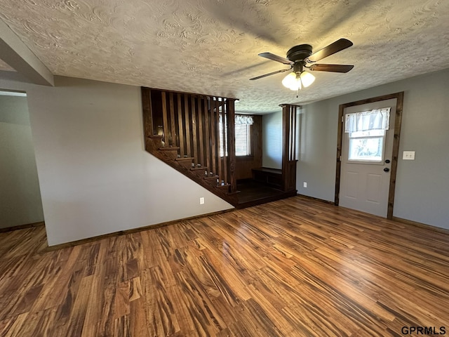 108 S Quince Ave, Dewitt, NE 68341 - entrance foyer with stairs, a textured ceiling, wood finished floors, and a ceiling fan