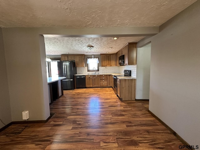 108 S Quince Ave, Dewitt, NE 68341 - kitchen featuring dark wood-type flooring, black appliances, light countertops, decorative backsplash, and baseboards