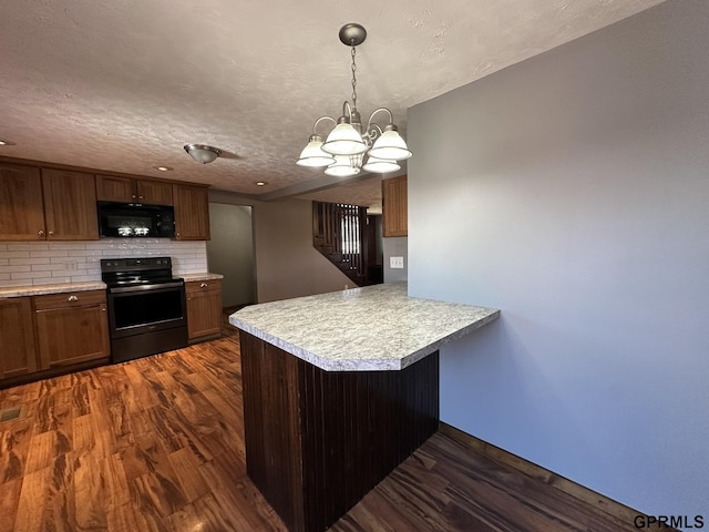 108 S Quince Ave, Dewitt, NE 68341 - kitchen featuring black appliances, a peninsula, dark wood-style flooring, and light countertops