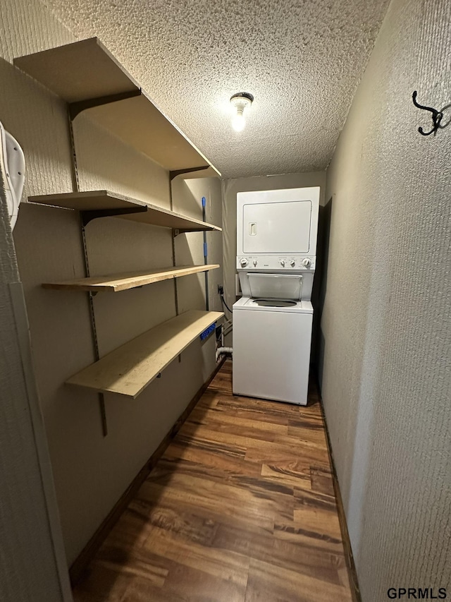 108 S Quince Ave, Dewitt, NE 68341 - washroom featuring dark wood-style floors, laundry area, stacked washer and clothes dryer, a textured ceiling, and a textured wall