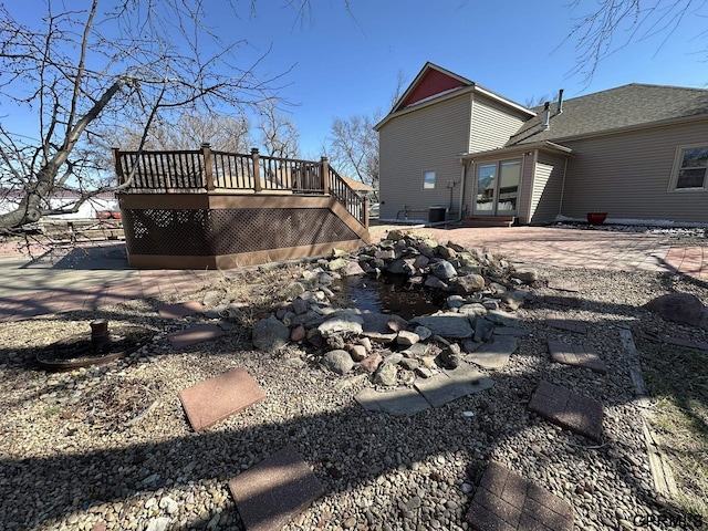 108 S Quince Ave, Dewitt, NE 68341 - rear view of house featuring stairs, a patio, and a wooden deck