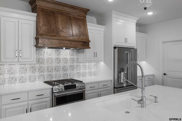 10907 N 167th St, Bennington, NE 68007 - kitchen featuring appliances with stainless steel finishes, custom range hood, white cabinets, recessed lighting, and backsplash