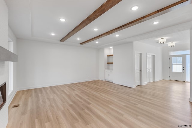 10907 N 167th St, Bennington, NE 68007 - unfurnished living room featuring light wood-type flooring, beamed ceiling, a fireplace, baseboards, and recessed lighting