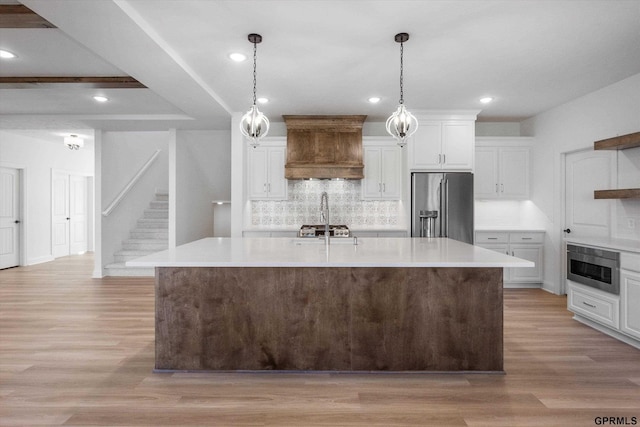 10907 N 167th St, Bennington, NE 68007 - kitchen featuring high quality fridge, tasteful backsplash, light countertops, light wood finished floors, and recessed lighting