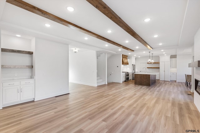 10907 N 167th St, Bennington, NE 68007 - unfurnished living room featuring beam ceiling, light wood finished floors, stairway, a fireplace, and recessed lighting