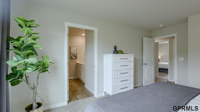 13607 Whitmore St, Omaha, NE 68142 - bedroom featuring baseboards, ensuite bathroom, and light wood-style flooring