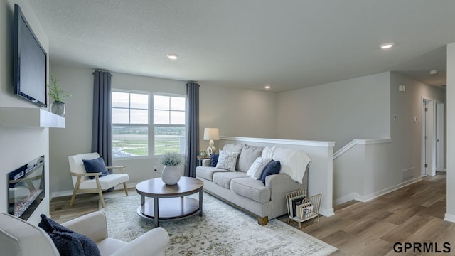 13607 Whitmore St, Omaha, NE 68142 - living area featuring wood finished floors, baseboards, and recessed lighting