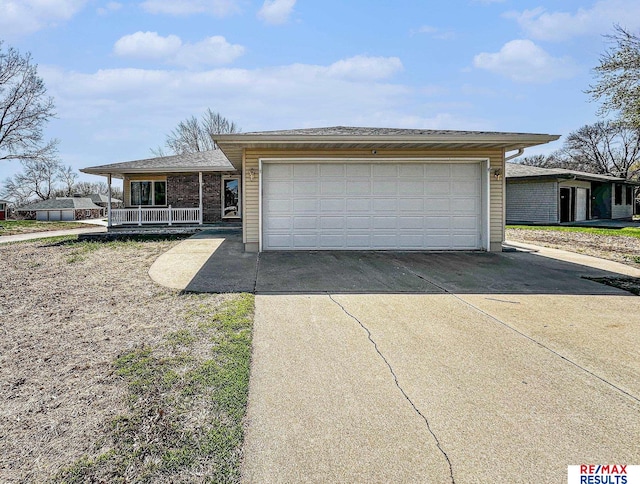 view of front of property featuring brick siding, a porch, and driveway