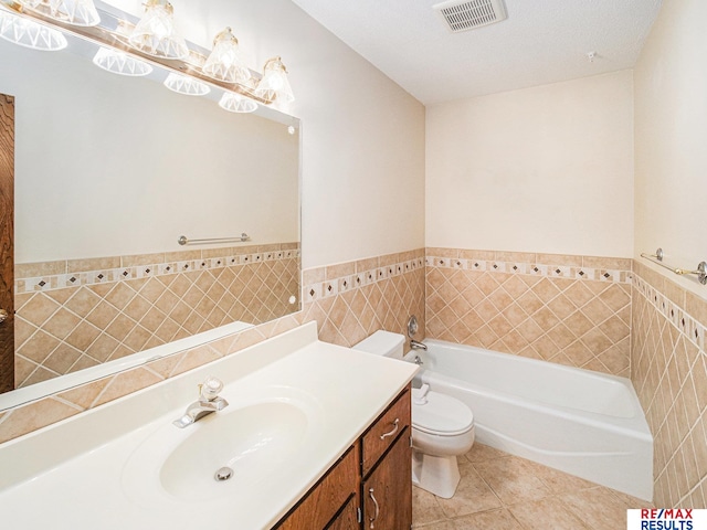 bathroom with tile patterned floors, toilet, visible vents, tile walls, and a garden tub