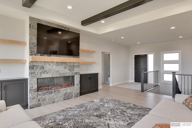 living area with beam ceiling, a fireplace, light wood-type flooring, baseboards, and recessed lighting