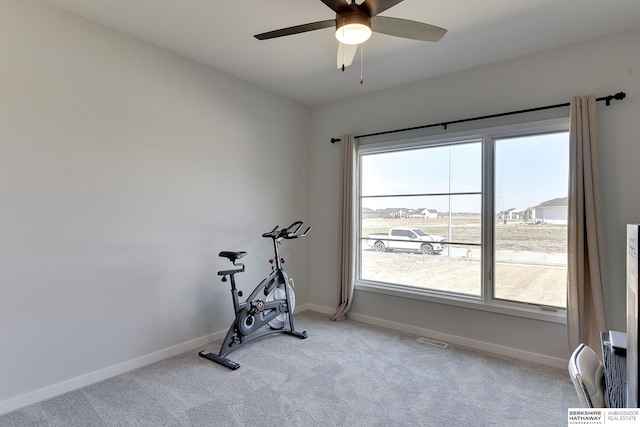 workout room featuring carpet flooring, a ceiling fan, baseboards, and visible vents