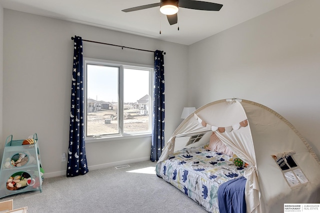 carpeted bedroom featuring baseboards, ceiling fan, and visible vents