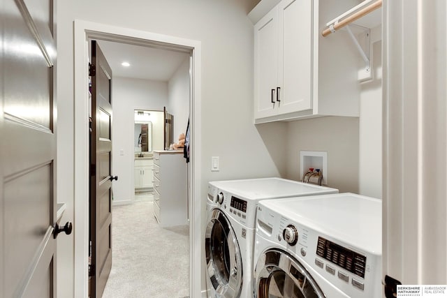 laundry room featuring cabinet space, separate washer and dryer, and light carpet