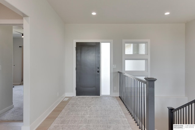 entrance foyer with baseboards and recessed lighting
