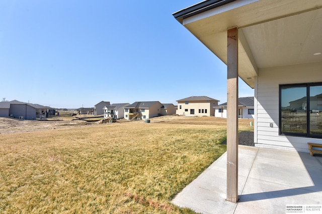 view of yard with a residential view and a patio area
