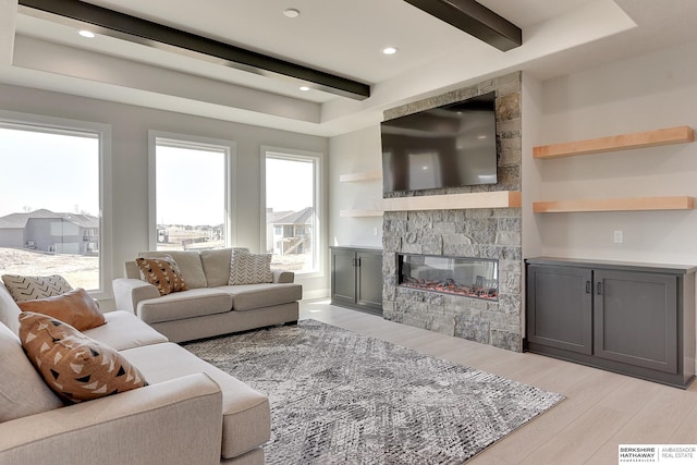 living area with beamed ceiling, a fireplace, light wood-style flooring, and recessed lighting