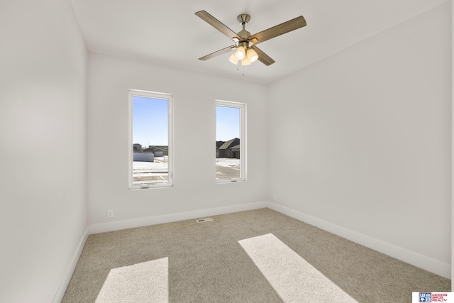 unfurnished room with baseboards, visible vents, ceiling fan, and carpet flooring