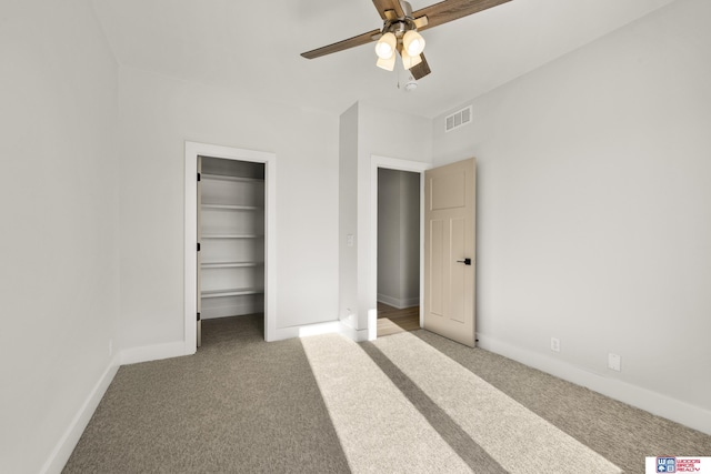 unfurnished bedroom featuring carpet floors, baseboards, and visible vents